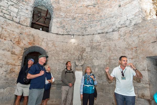 Guests listening to a guide in a round domed stone room
