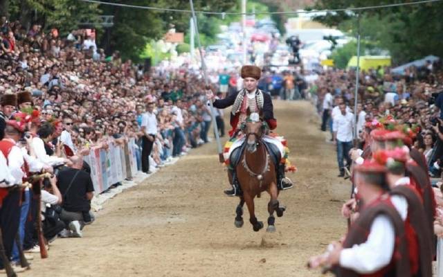 A rider in traditional costume at full gallop during the Alka tournament in Sinj