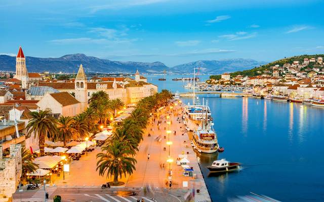 Trogir seafront promenade with palm trees at dusk
